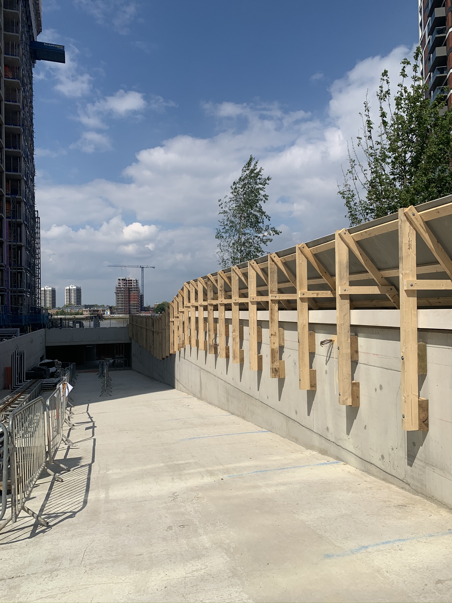 Timber frame walkway cover structure on a construction site